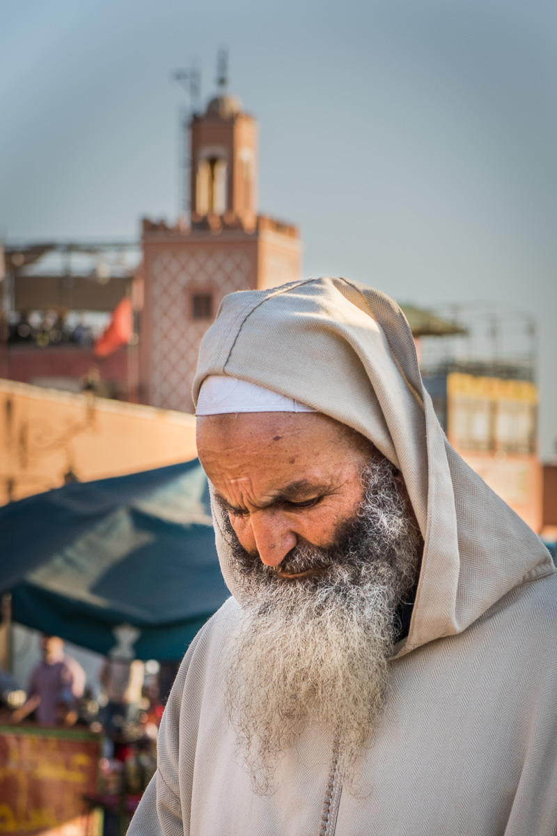 Jemaa el-Fna Square: local man wearing a jilaba, the traditional outer garment worn by most men in Morocco