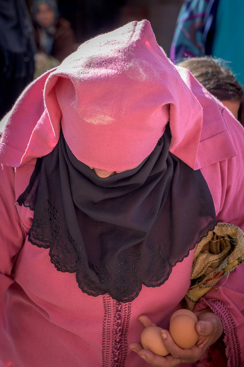 Jemaa el-Fna Square: local woman wearing a kaftan (woman’s traditional outer garment) and veil