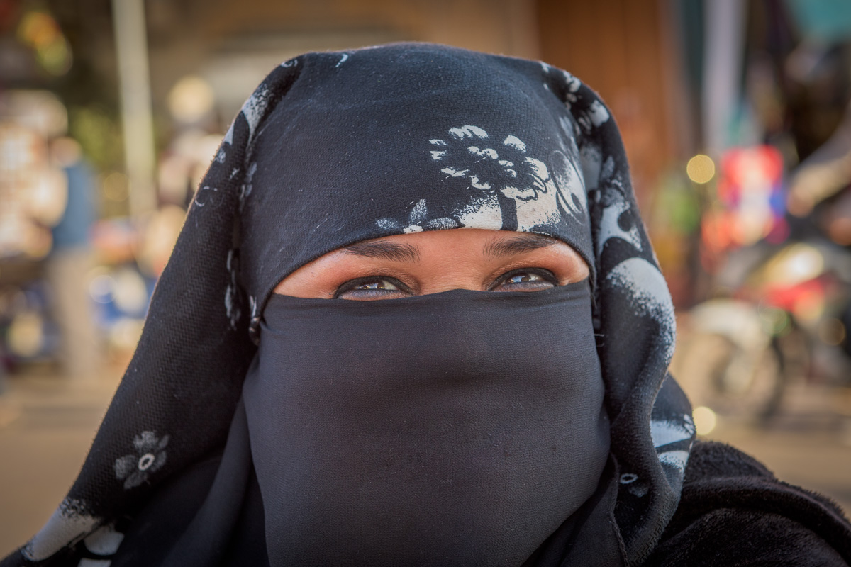 Jemaa el-Fna Square: local woman wearing a niqab, a traditional head-scarf worn throughout Morocco