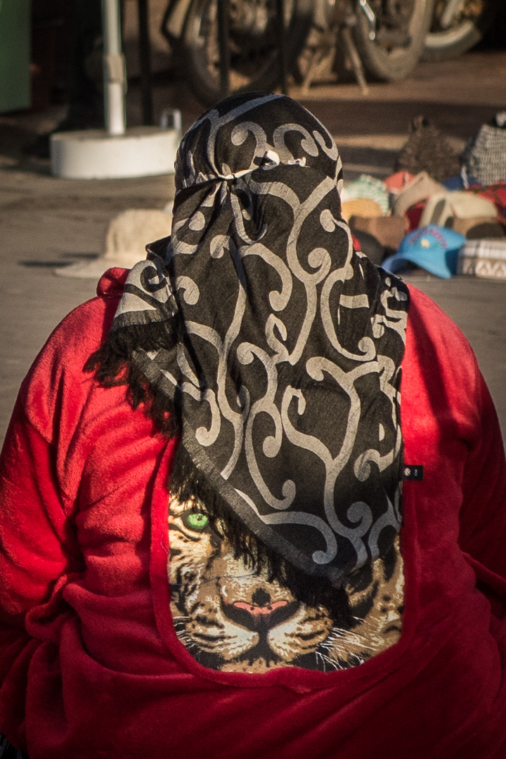 Jemaa el-Fna Square: local woman wearing a kaftan (woman’s traditional outer garment) and niqab (head scarf)