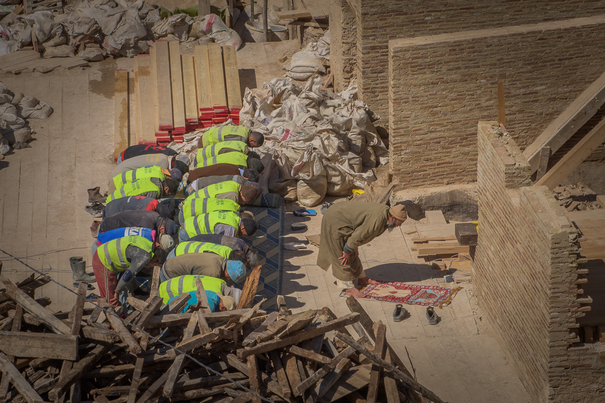 Local laborers stop their work to observe one of the five calls to prayer each day.